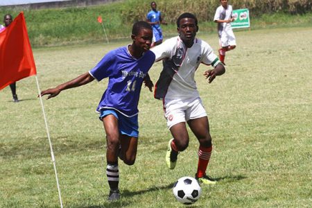 Action in the Milo Secondary School Football Championship between Ann’s Grove and Friendship at the Ministry of Education ground, Carifesta Avenue yesterday