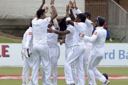 The Sri Lanka team celebrates.
