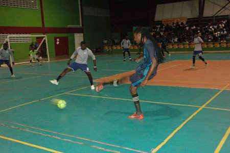 Gold is Money’s Jamal Pedro in the process of completing a pass into the Melanie defensive third during their matchup in the 2nd Annual NSC/Magnum Mash Futsal Championship at the National Gymnasium, Mandela Avenue