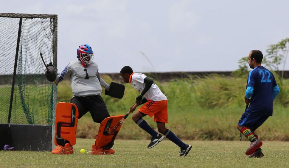 Meshach Sargeant [center] of Bounty GCC in the process of scoring one of his two goals against Saints during their clash at the St. Stanislaus College ground in the Farfan & Mendes Men’s Division One league.

