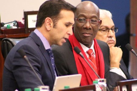 Prime Minister Dr Keith Rowley speaks with Attorney General Faris Al-Rawi during a parliament sitting yesterday.