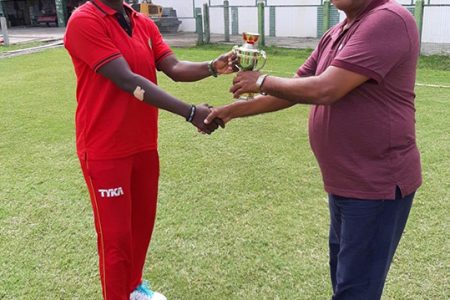 Player of the Match, Tremayne Smartt accepting her prize from Match Referee Moses Ramnarine
