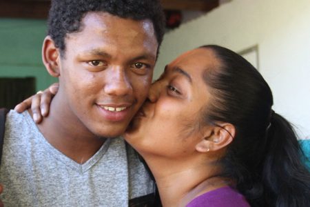 Kenrick Morgan is kissed by his sister Tracy Alexander on his return to his Moruga home yesterday.