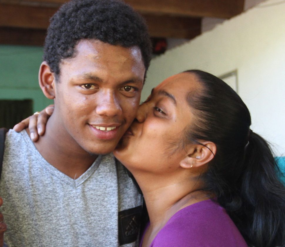 Kenrick Morgan is kissed by his sister Tracy Alexander on his return to his Moruga home yesterday.