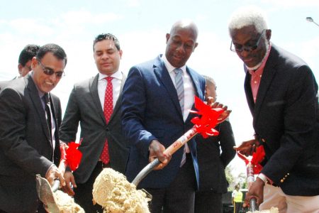 Prime Minister Dr Keith Rowley, centre, with Minister of Works and Transport Rohan Sinanan, left, and Nidco chairman Hubert George turn the sod for Curepe Interchange Project, at Curepe yesterda. In background is Housing Minister Randall Mitchell.