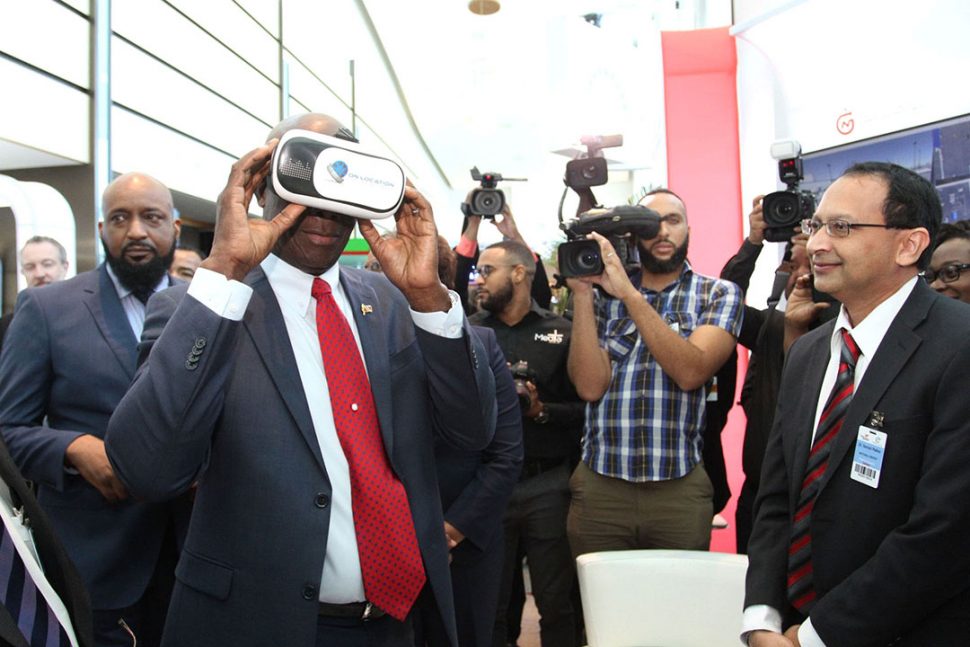 Prime Minister Dr Keith Rowley, left, views the National Energy Explorers using virtual reality technology during his visit to the NGC booth at the Energy Conference of Trinidad and Tobago 2019 at the Hyatt Regency, Port-of-Spain, yesterday.