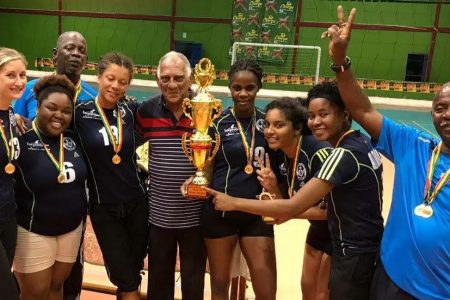 Former Guyana Volleyball Association president Lenny Shuffler (centre) poses for a photo with the female champions. 