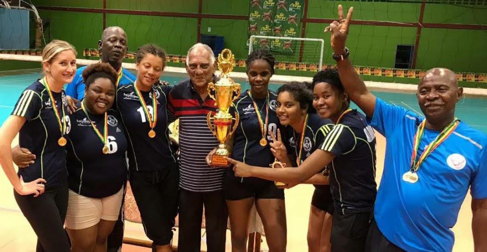 Former Guyana Volleyball Association president Lenny Shuffler (centre) poses for a photo with the female champions. 