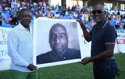 From one captain to another: Sir Vivian Richards (right) receives the portrait from Sir Richie Richardson at the Vivian Richards Cricket Ground.