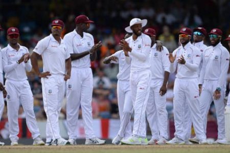 The West Indies players celebrate their victory over England.