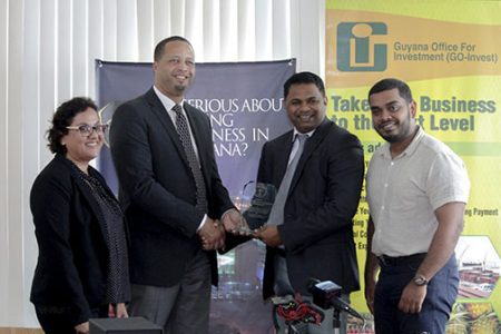GO-Invest CEO Owen Verwey (second from left) receiving an award recently from Georgetown Chambers of Commerce President Deodat Indar