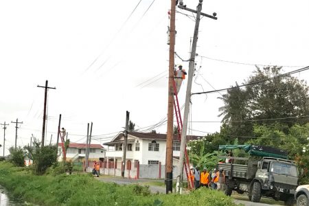 Employees of the Guyana Power and Light working to reconnect the power cables yesterday afternoon.