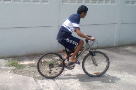 Gopaul Etwaroo riding a bicycle last July as part of his physical therapy.