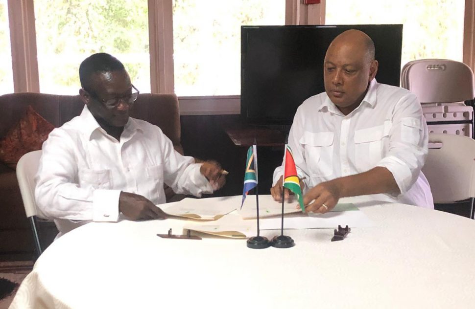 Republic of South Africa’s Deputy Minister of Mineral Resources Godfrey Oliphant (left) signing the declaration of intent with Minister of Natural Resources Raphael Trotman yesterday.