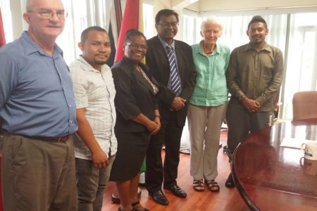 Minister of Public Security Khemraj Ramjattan (third, from right) with Sabine McIntosh, Director of the Deaf Association of Guyana (second, from right), Beverly Pile (at centre) of the National Commission on Disability and others last Thursday. (Ministry of Public Security photo) 