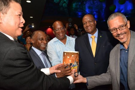 Vice President, Carl Greenidge (second from left), Minister of Finance,  Winston Jordan (centre), Minister of State, Joseph Harmon (second from right), Minister of Business, Dominic Gaskin (right) and Chairman of MovieTowne, Derrick Chin pose with a bag of popcorn as they commissioned the MovieTowne Guyana facility at Turkeyen last evening.  The estimated US$40M investment by the Trinidad-based Chin features cinemas, restaurants and other attractions. (Ministry of the Presidency photo)