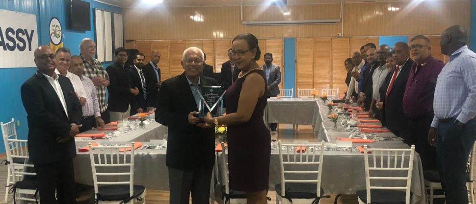 Outgoing Chairman of Massy Guyana Deo Persaud receiving the award from Executive Director of the Private Sector Commission Elizabeth Alleyne last night.
