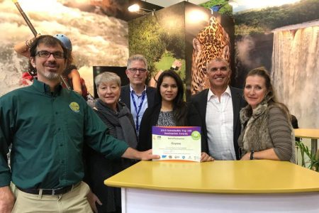  Director of Tourism Brian Mullis (left) displaying the Award in the Guyana Booth at the Berlin event on Tuesday
