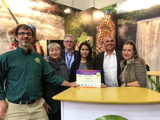  Director of Tourism Brian Mullis (left) displaying the Award in the Guyana Booth at the Berlin event on Tuesday
