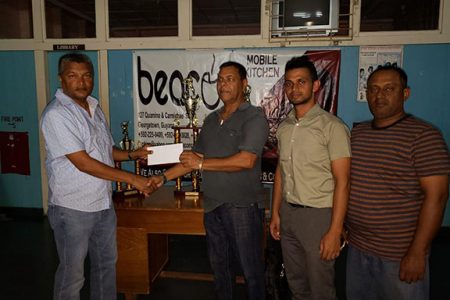 WDCA President Anand Sanasie (extreme left) receives the sponsorship cheque and trophies from Beacon Cafe representative in the presence of the WDCA competition Secretary and Chairman.