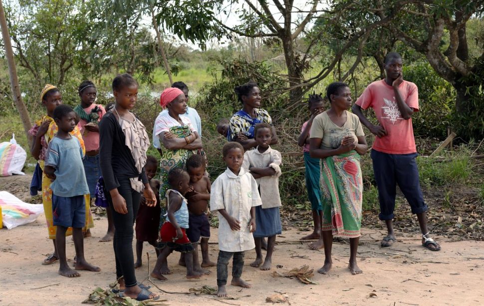 People wait to collect food parcels handed out by an aid organisation to locals after Cyclone Idai, near Dondo village outside Beira, Mozambique. (Reuters photo)