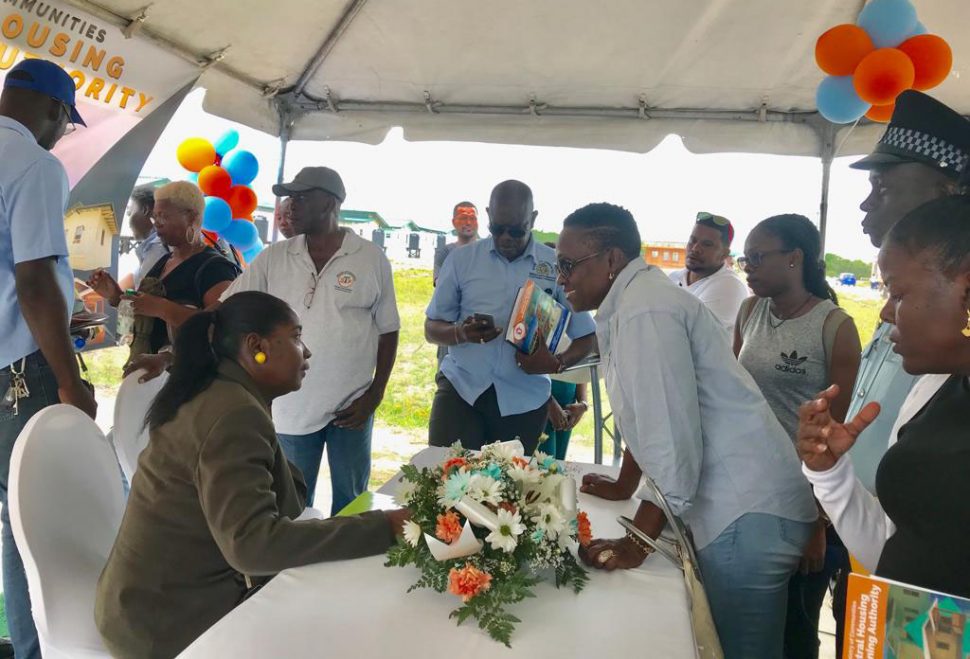 Minister of Communities with the responsibility for housing Valerie Adams-Patterson interacting with one of the attendees at the open house event yesterday.