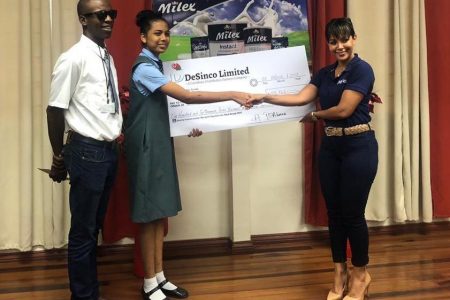 De Sinco-Milex supports chess: Isha De Abreau (right) an official of De Sinco Trading hands over a cheque to St Stanislaus College student Chelsea Juma for her to attend the Carifta Games in Curacao this month. At left is Wendell Meusa, a FIDE national chess instructor and head of the Wendell Meusa Chess Foundation of which Juma is a student. Juma said her desire is to return to Guyana with a medal and a win for her country.