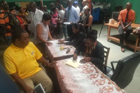 The team from Central Housing & Planning Authority reviewing documents at the outreach held at Guyana Society for the Blind on High Street, Werk-en-Rust. 