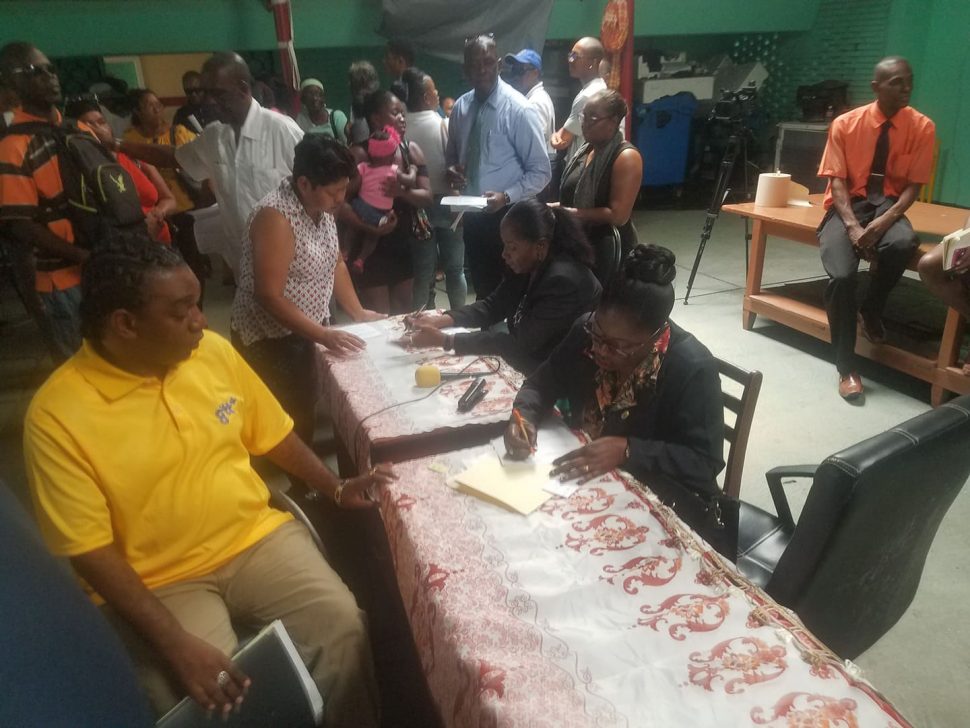 The team from Central Housing & Planning Authority reviewing documents at the outreach held at Guyana Society for the Blind on High Street, Werk-en-Rust. 