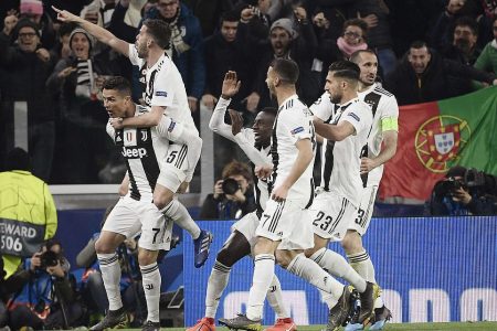 The Juventus players celebrate with Ronaldo, left, a goal by their iconic star player.

