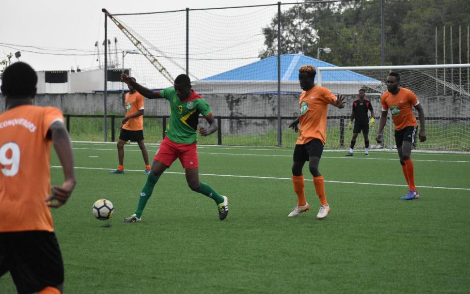 Surrounded! Delon Lanferman of the Golden Jaguars Local Provisional Squad, attacks the ball while being encircled by several Fruta Conquerors players during the side’s embarrassing 0-1 loss at the National Training Centre, Providence.
