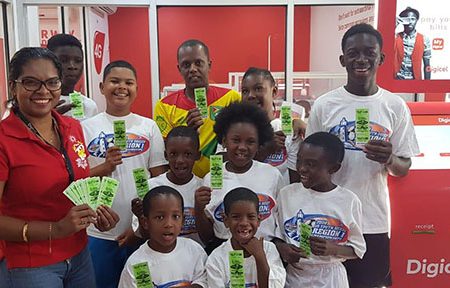  Youths from the Kingston and Tiger Bay communities receive their CONCACAF Nations League Guyana vs. Belize tickets at Digicel’s Head office in Kingston. In the photo is Digicel Communications Director Vidya Sanichara
