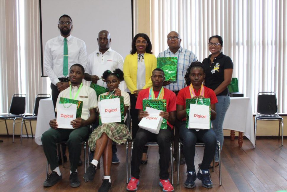 Four of the athletes pose with officials at yesterday’s event at the National Resource Centre.
