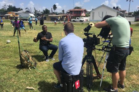 FIFA Football Producer Andrew Tomczak conducting an interview with GFF President Wayne Forde at a GFF Kool Kidz Grassroots Session in Georgetown.