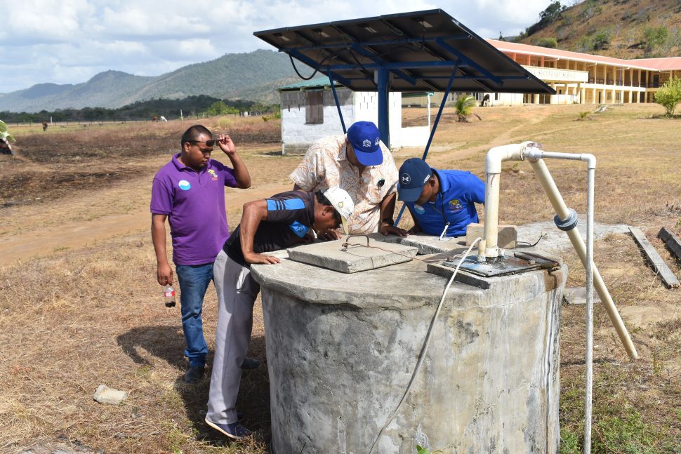GWI personnel inspecting a well (GWI photo)