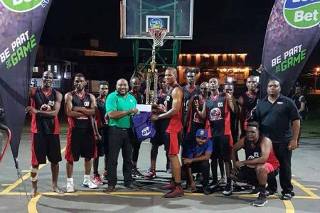 Kobras Basketball Club collecting their championship prize after defeating Guardians in the division one final at the Burnham Court in the [GABA]/’Lets Bet Sports’ championships.