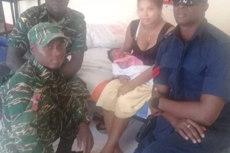 Aloma Roberts (seated at centre) with her newborn baby and ranks who conducted the medical transport. 