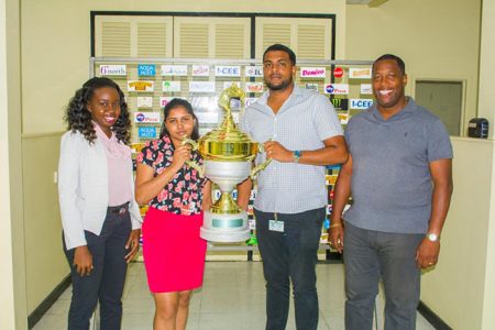 Nasrudeen Mohamed Jr. (second right) alongside Mortimer Stewart of Banks DIH Limited (right) poses with the championship trophy during the presentation earlier in the week.