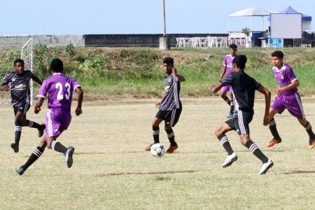 Action between Charlestown [green] and Annandale at the Ministry of Education ground in the Milo Secondary School Football Championship quarterfinal round

