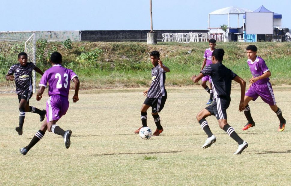 Action between Charlestown [green] and Annandale at the Ministry of Education ground in the Milo Secondary School Football Championship quarterfinal round
