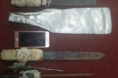 The improvised weapons and the cellular phone that were seized in the raid subsequent to the posting of the video.
