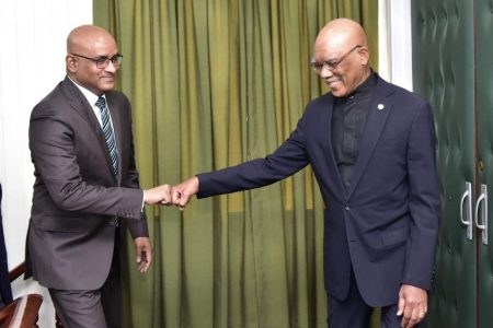 President David Granger (right) and Opposition Leader Bharrat Jagdeo in a fist bump before their talks last week. (Ministry of the Presidency photo)

