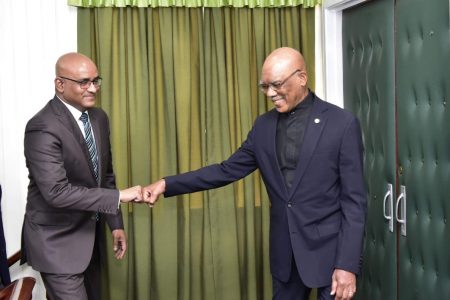 President David Granger (right) and Opposition Leader Bharrat Jagdeo in a fist pump before yesterday’s talks. (Ministry of the Presidency photo)