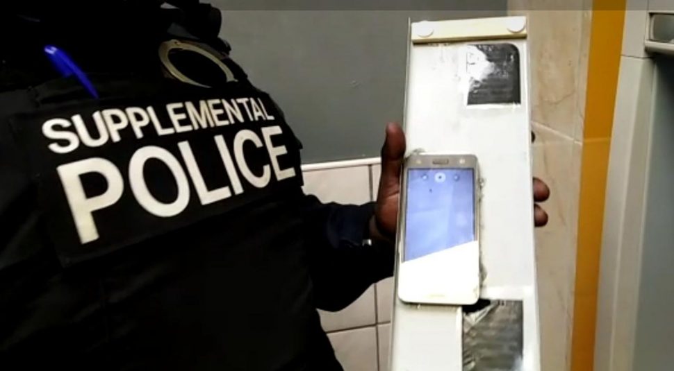 A screen grab of the Supplemental Police officer showing the fake panelling hidden at the top of an ATM machine which was used to hide a cellphone which was photographing customers’ pin numbers. The officers discovered the device Thursday night after receiving information.