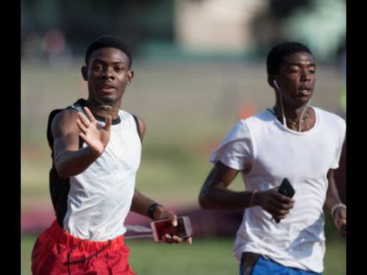 Calabar High sprint sensation Christopher Taylor (left) and middle-distance star Kimar Farquharson go through a training drill at the school’s Red Hills Road compound yesterday. Taylor, captain of the school’s Champs track team, waved away the photographer as the Gleaner news team sought to find out whether he and school officials were aware of the teacher assault.