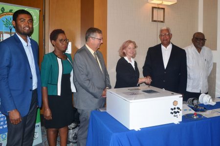 US Ambassador Sarah-Ann Lynch (third from right) hands over a weather station to Minister of Agriculture Dr Noel Holder. At right is Deputy Director of the CCCCC, Dr Ulric Trotz. At left is Chief Hydrometeorological Officer (ag) Dr Garvin Cummings. (Ministry of Agriculture photo)

