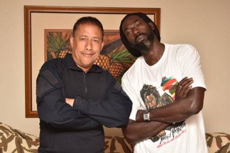Police Commissioner Gary Griffith strikes a pose with Jamaican reggae artiste Buju Banton after meeting him at the Hilton Trinidad Saturday night. Griffith met with Banton to assure him that the rest of his stay in T&T would be comfortable after officer raided Banton's hotel room hours before.