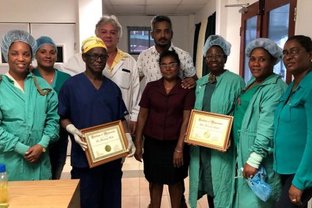 The visiting doctor and nurse from Ghana (holding framed certificates) along with staff of the National Ophthalmology Hospital. Dr Devendra Radhay is at the centre of the group. 