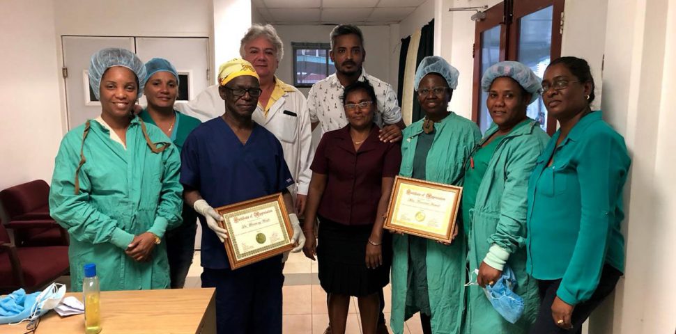 The visiting doctor and nurse from Ghana (holding framed certificates) along with staff of the National Ophthalmology Hospital. Dr Devendra Radhay is at the centre of the group. 