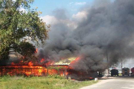 The regional stores building engulfed in flames. (Regional Democratic Council Region Seven photo)
